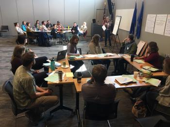 Large room with scientists and managers at a workshop