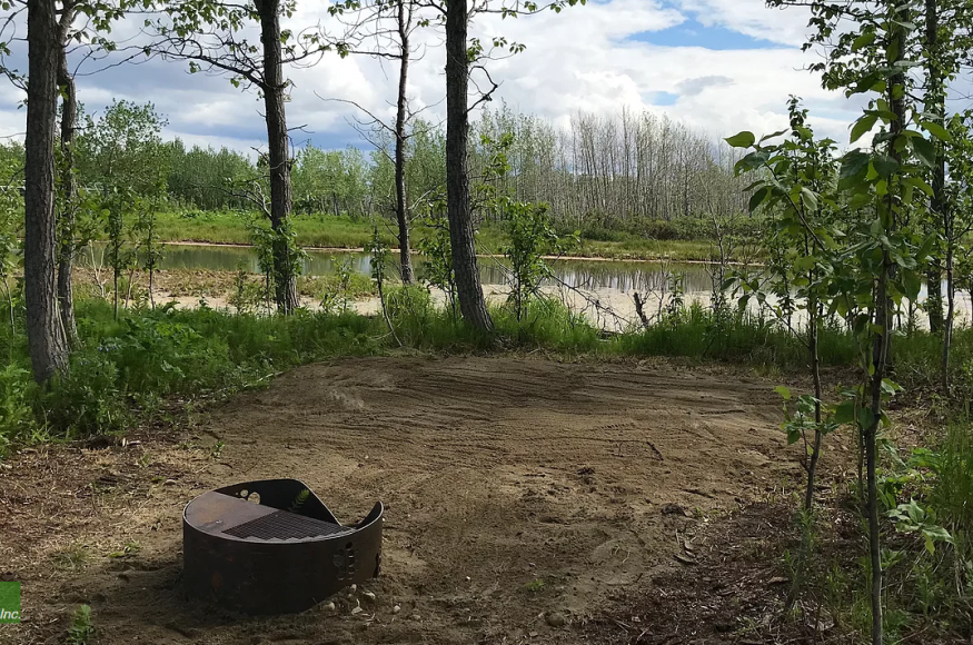 Picture of a campsite with a fire ring at Pilgrim Hot Springs