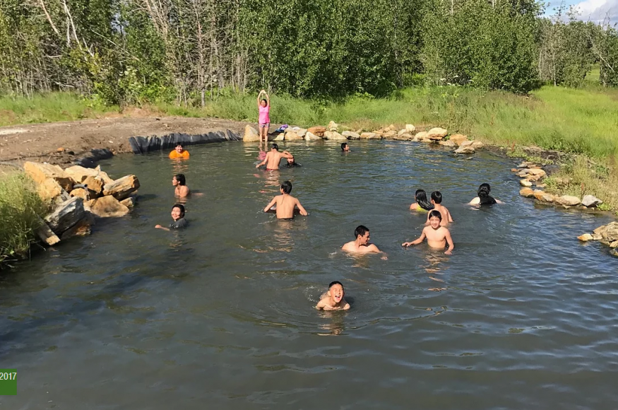 Picture of people soaking in a hot spring pool